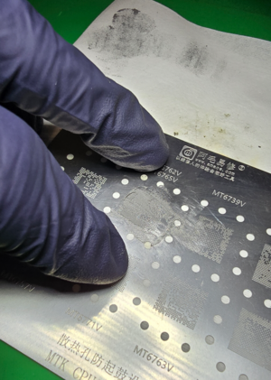 Holding stencil down with 2 fingers.png