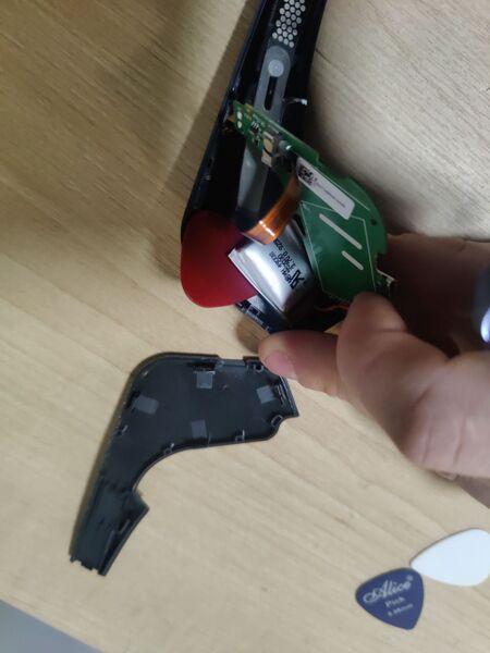 File:Using pick to undo battery glue on Muse (2016).jpg