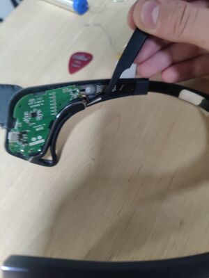 Using tweezers to remove the ear electrode connection on the Muse (2016)