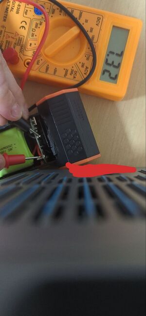 A partially disassembled MF50 with the battery voltage being probed. The voltage shows as 7.32, which is not far off from the nominal voltage of 7.4 volts.